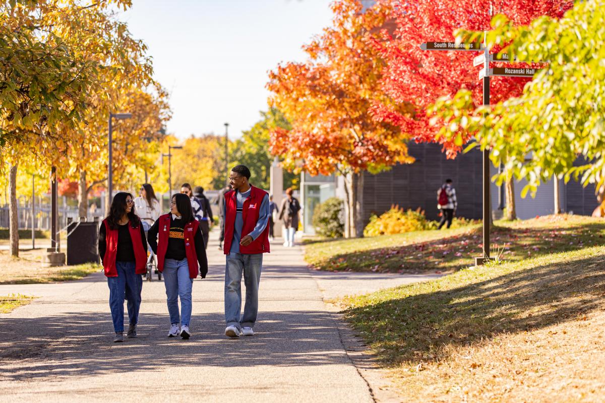 Three RLS members standing in front of Johnston Hall