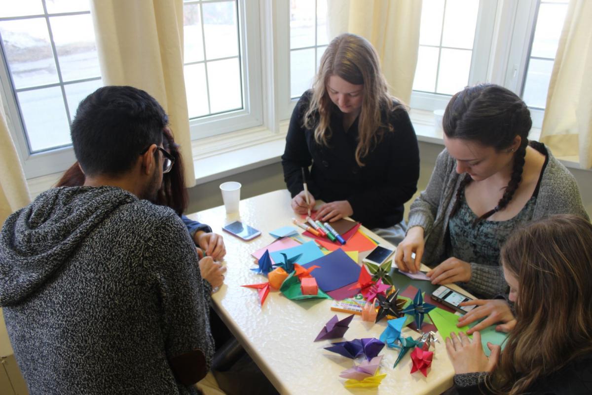 Group of students working with colorful materials and creating art