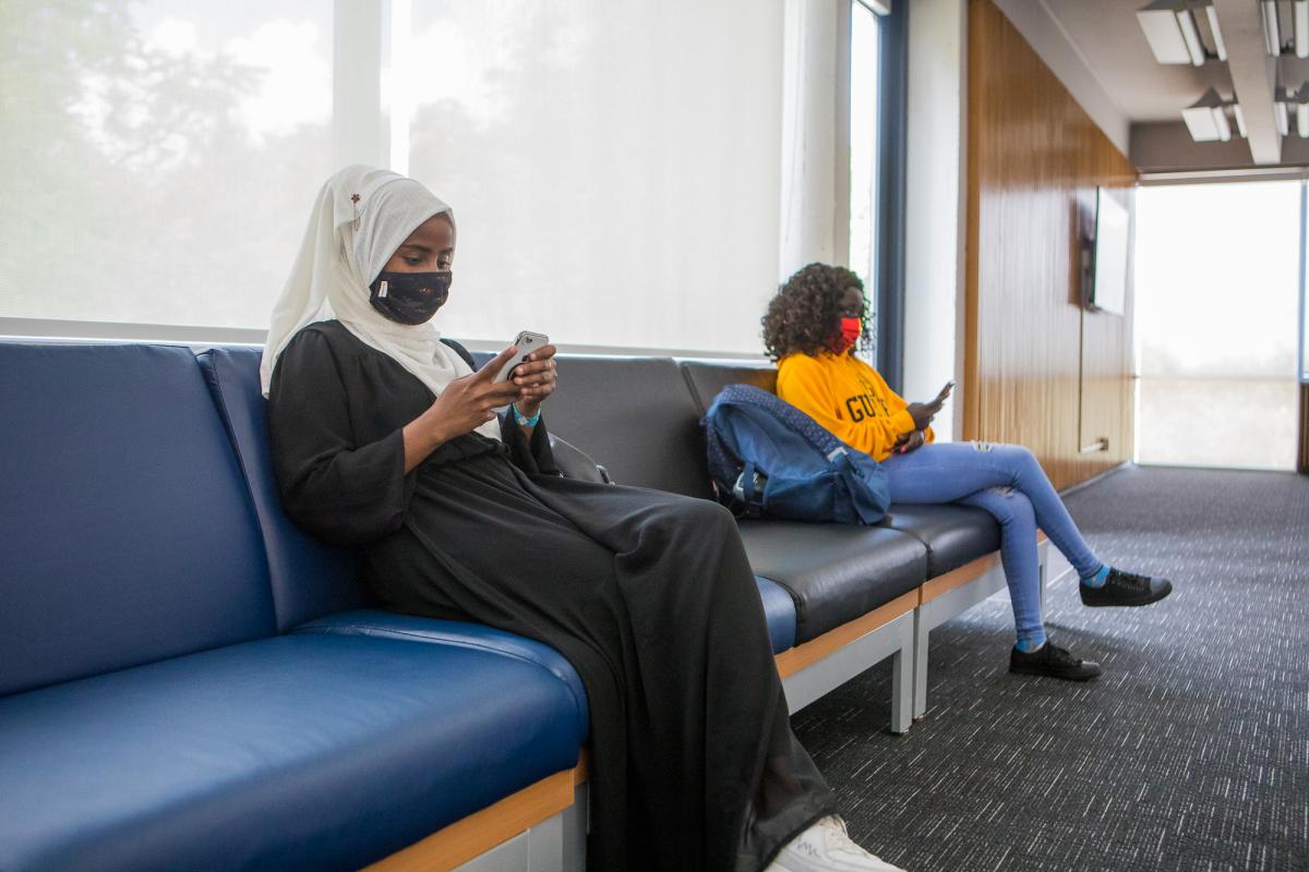 photo of two students sitting in a common lounge