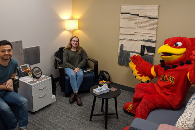 Students talking with Gryphon mascot