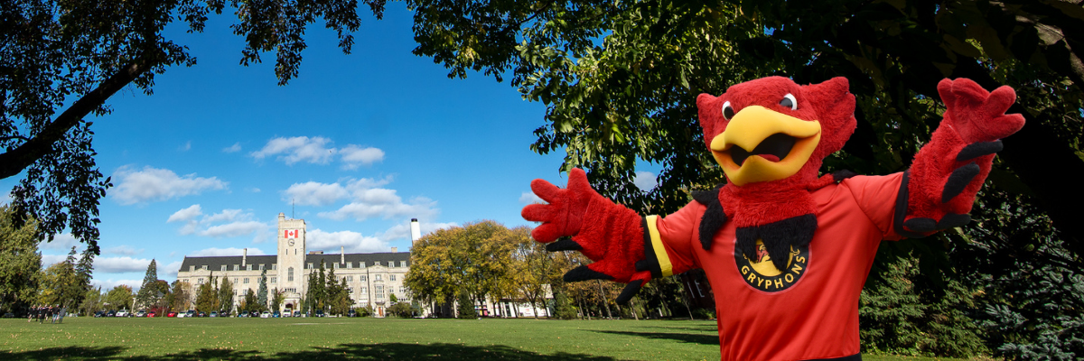Gryphon mascot in front of Johnston Hall